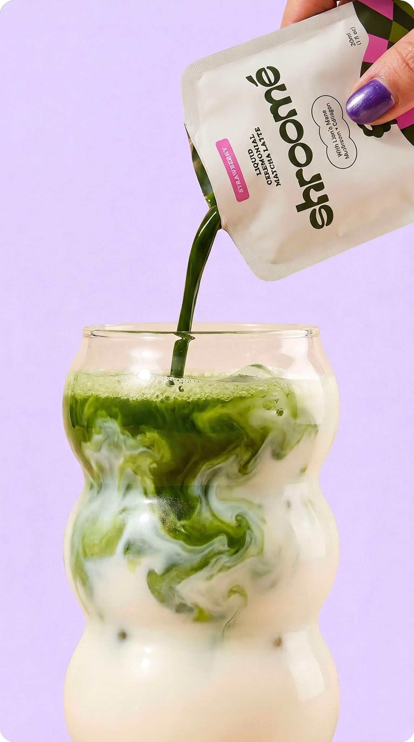 shroomé strawberry sachet pouring vivid green matcha over milk in a bubble glass