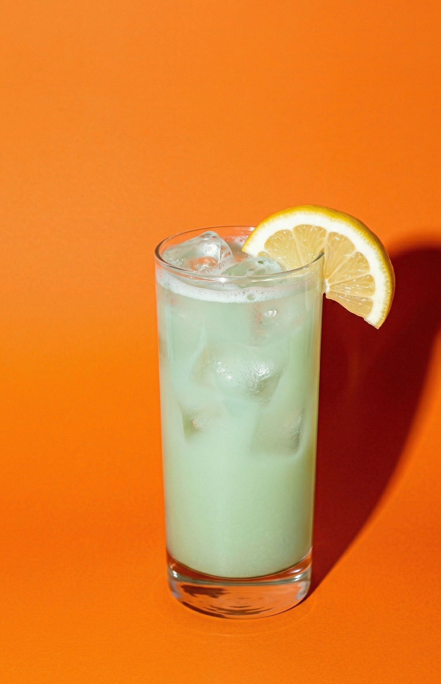 Strawberry Matcha Agua Fresca — light green matcha drink with lemon and ice in a tall glass