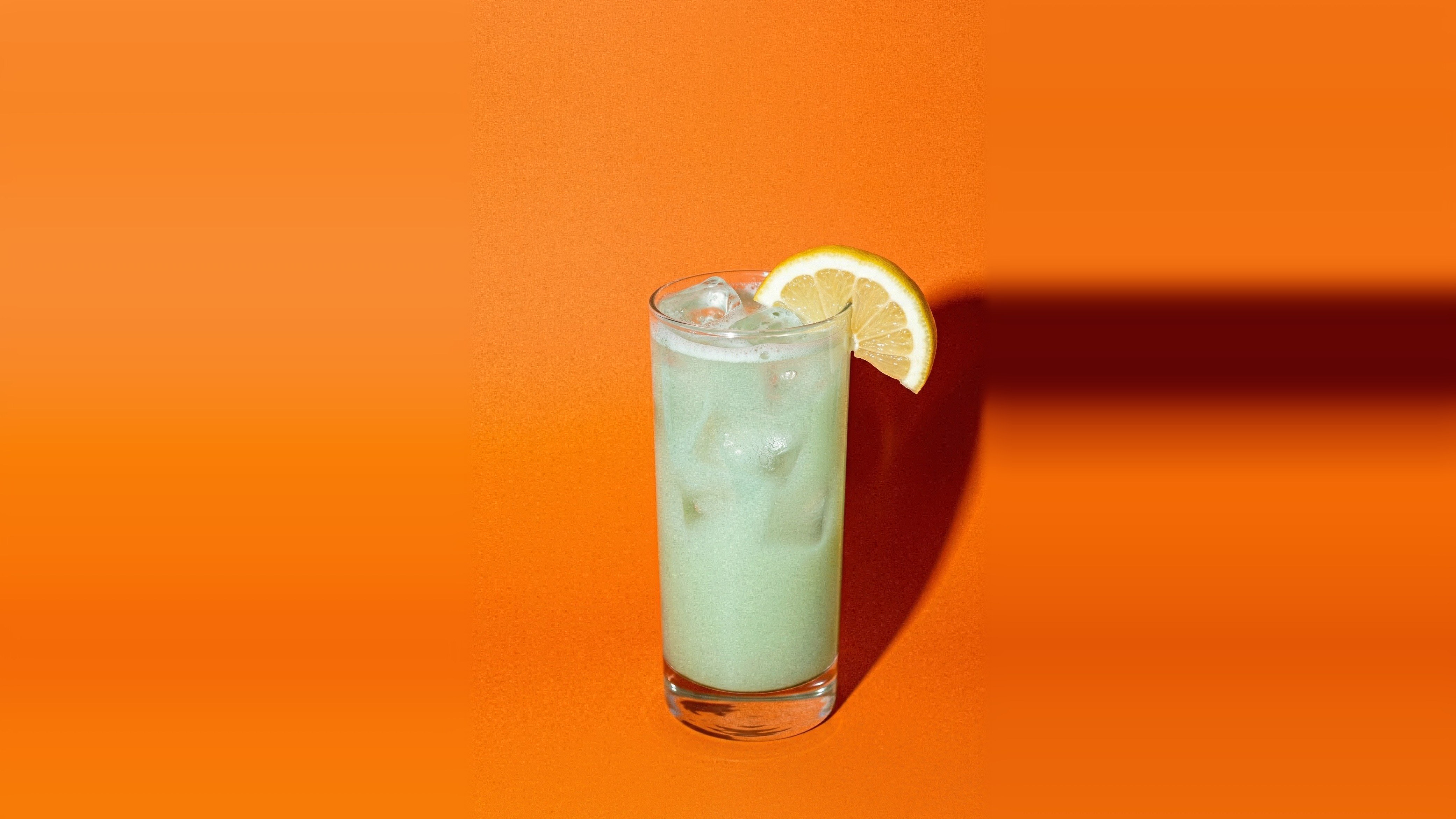 Strawberry Matcha Agua Fresca — light green matcha drink with lemon and ice in a tall glass