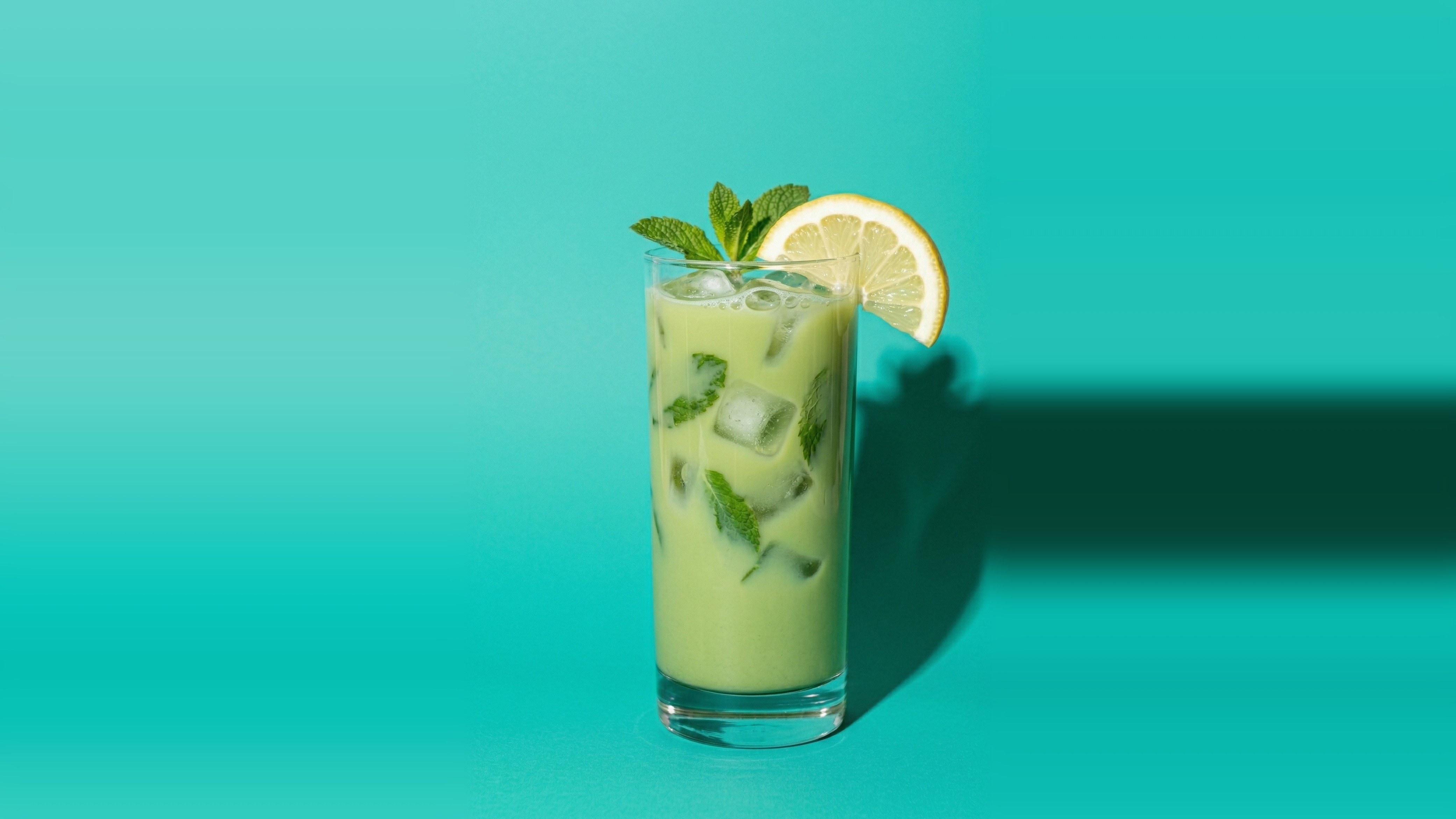 Coconut Water Matcha — refreshing green matcha with coconut water, mint leaves, and lemon in a tall glass