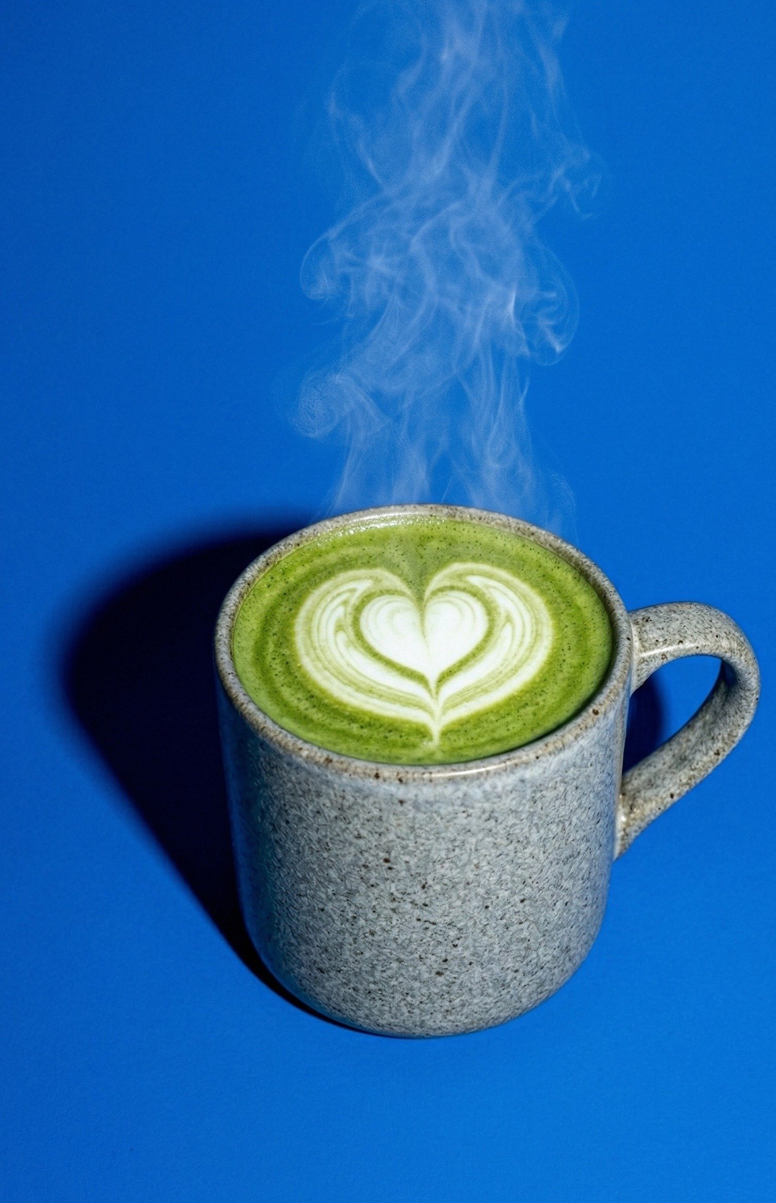 Hot Matcha Latte — steaming green matcha latte with latte art in a ceramic mug